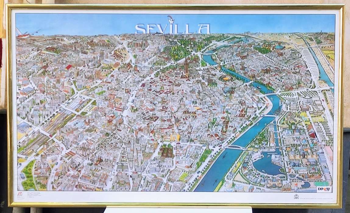 Lámina MAPA EXPO 92 enmarcado. Marco en metalñ dorado, con dos cáncamos para colgarlo. Ytasera con panel de madera y grapas.